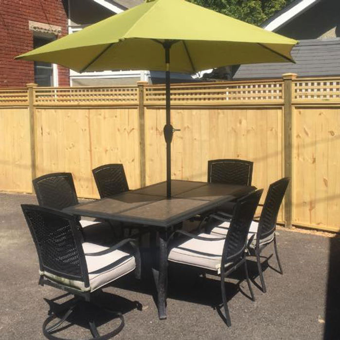 Wood privacy fence with lattice top around a patio