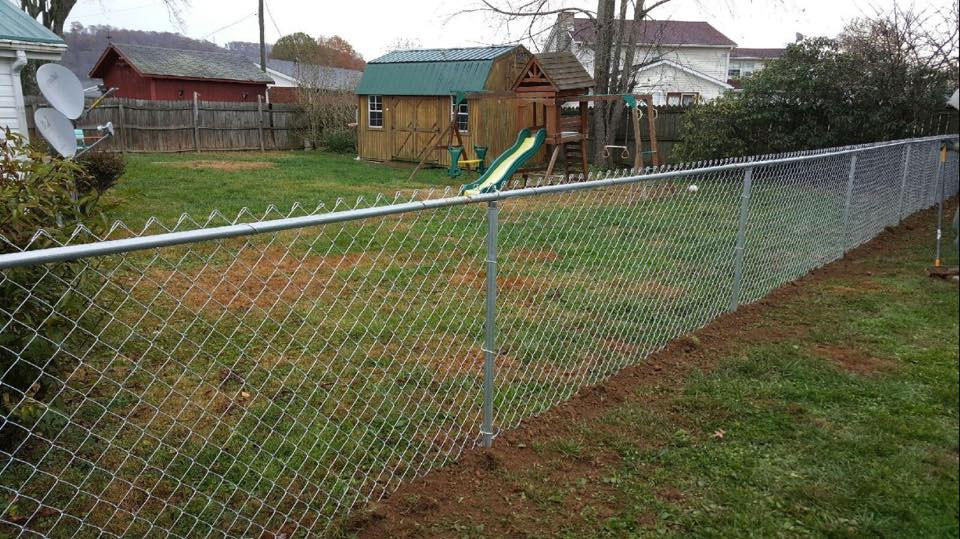 Residential chain-link fence along a backyard